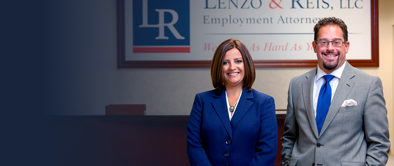 Christopher P. Lenzo and Claudia A. Reis with the logo of Lenzo & Reis, LLC on the wall in the background.